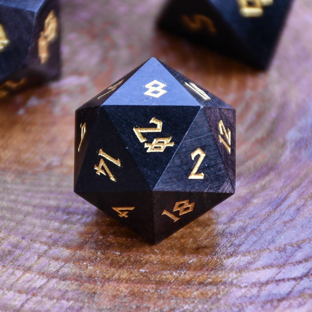 black wooden dice with gold numbers for dnd