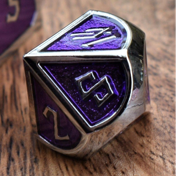 D12 dice with purple and silver design on a wooden surface