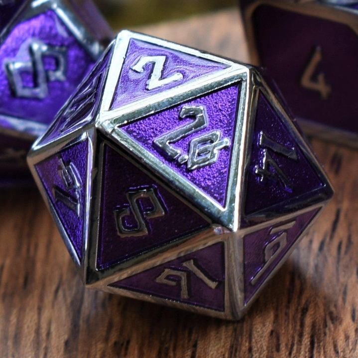 Purple polyhedral d20 dice with silver numbering on a wooden surface