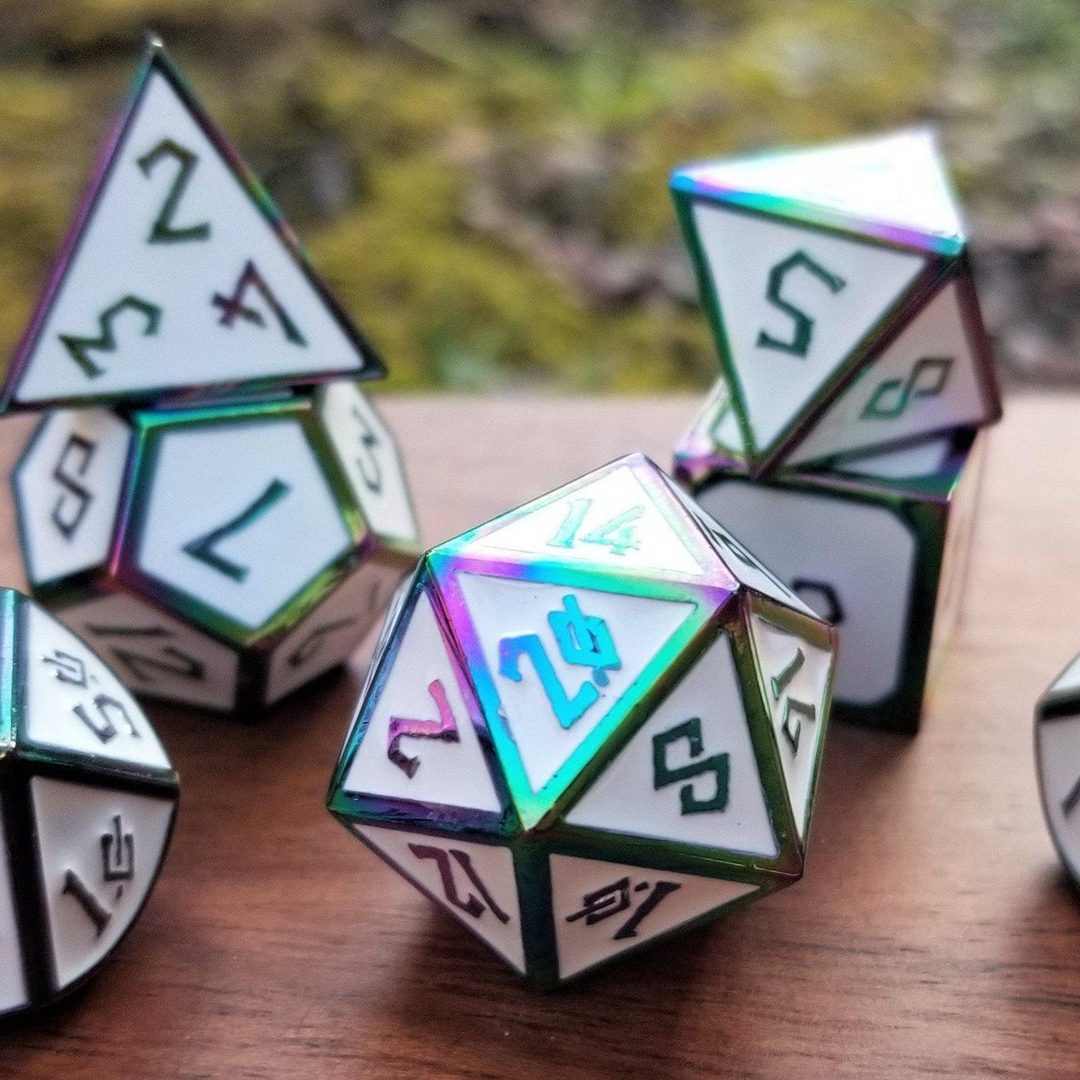 A set of white and iridescent metal dice with embossed numbers, displayed on a wooden surface.