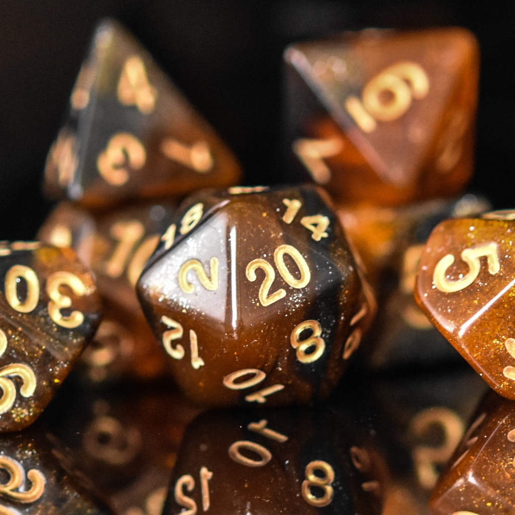 Close-up of brown polyhedral dice with gold numbers on a dark background