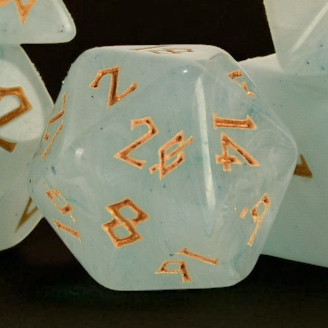 A set of pale jade acrylic dice with gold numbering 