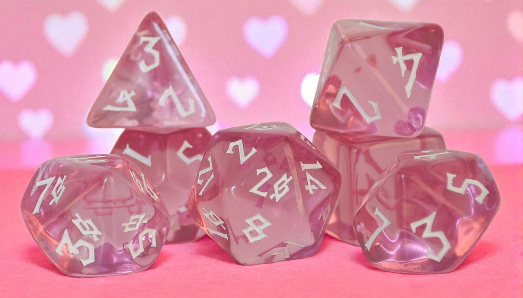 Pink clear acrylic dice set with white numbering in a nordic font for tabletop roleplaying games