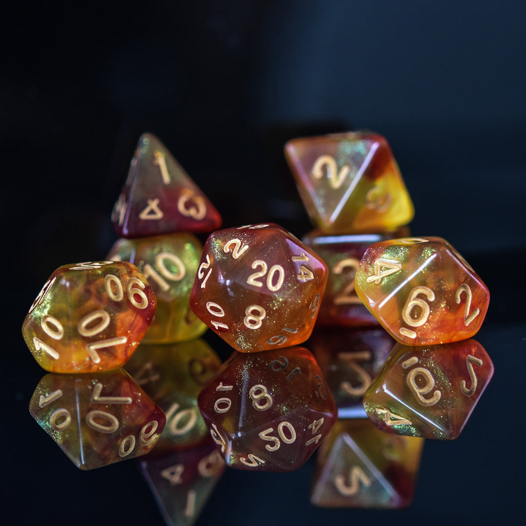 A set of shimmering orange acrylic dice with engraved gold numbers