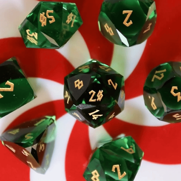 Emerald Multifaceted Glass Dice spinning on red and white candycane surface