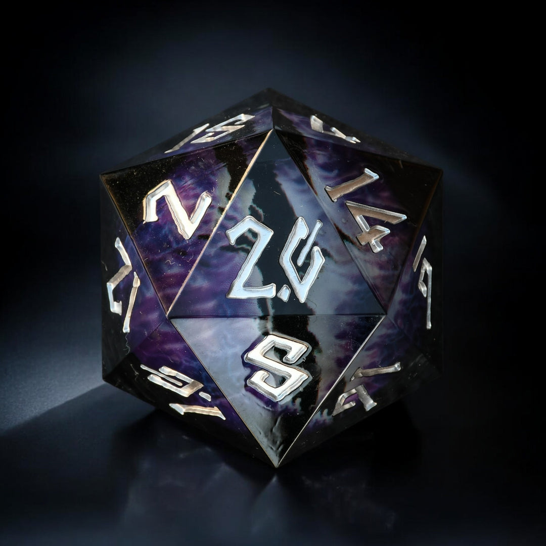 A 30mm black and silver oversized liquid core resin d20 dice with engraved numbers and a floating purple dragons eye design inside.