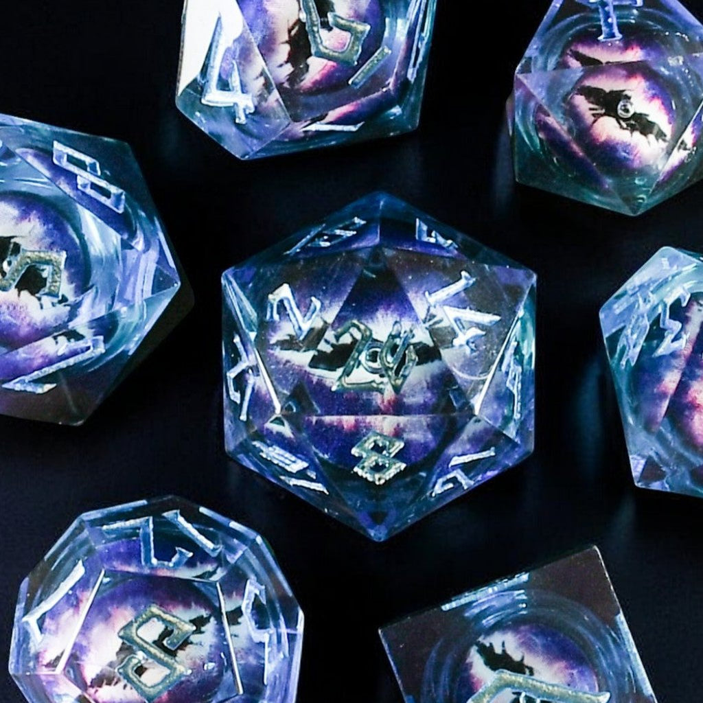 A set of resin dice with blue liquid core and purple eyes, including various shapes such as a d4, d6, d8, d10, d12, and d20, displayed on a dark background.
