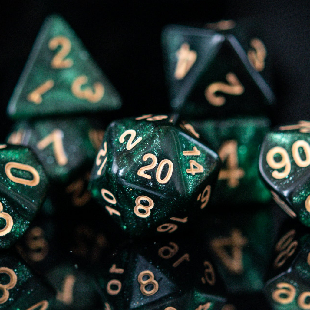 Close-up of green polyhedral dice with gold numbers on a black background