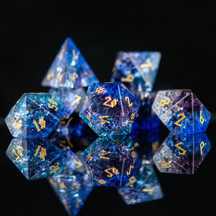 A set of hand-carved, multicolored glass dnd dice with engraved numbers, displaying a shattered glass effect.