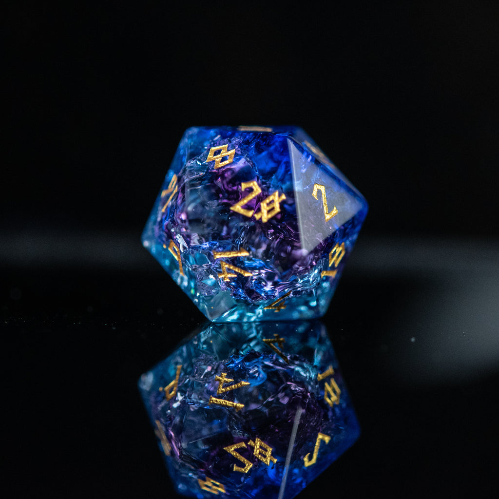A set of hand-carved, multicolored glass dnd dice with engraved numbers, displaying a shattered glass effect.