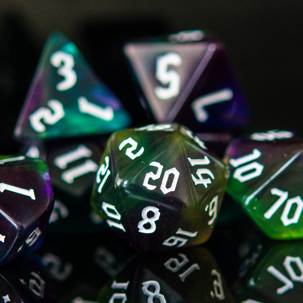 Close-up of polyhedral dice with green and purple colors on a dark background