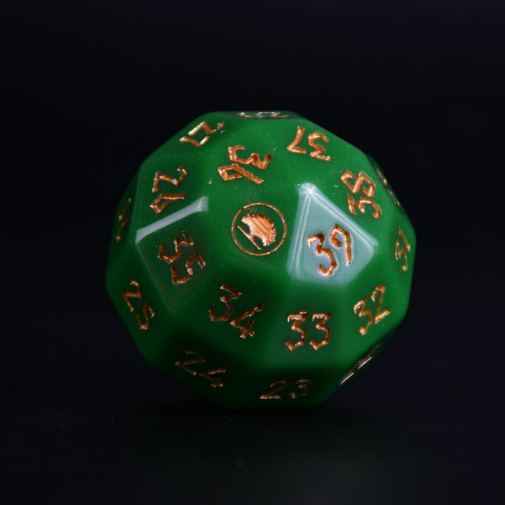 A green acrylic dice with engraved numbers and a symbol on one face, placed on a wooden surface.