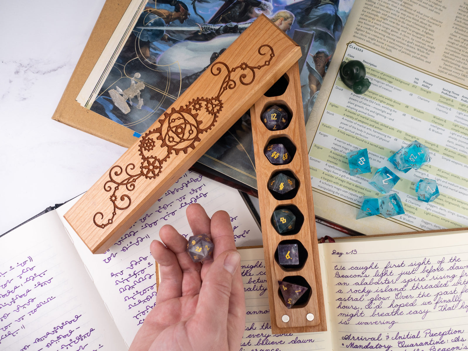 Wooden dice holder with engraved design on a table with gaming materials