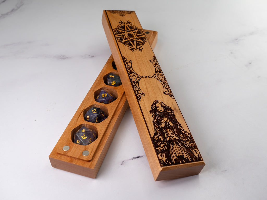 Wooden dice holder with engraved design on a white marble surface