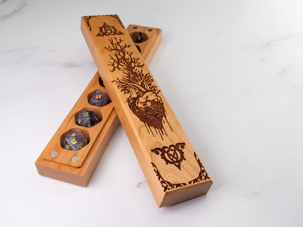 Wooden dice tray with engraved designs on a white background