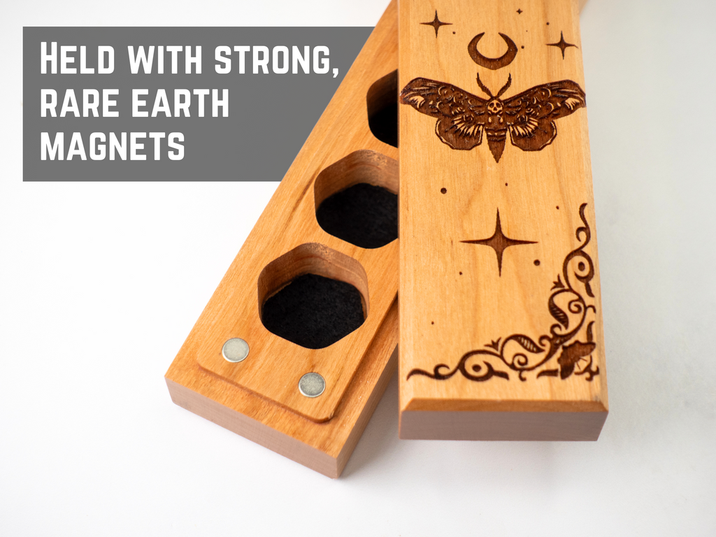 Wooden magnetic dnd dice holder with engraved designs on a white background