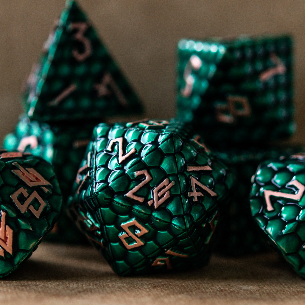 A set of green metal dice with embossed numbers, including various shapes such as a d4, d6, d8, d10, d12, and d20, displayed on a textured background.