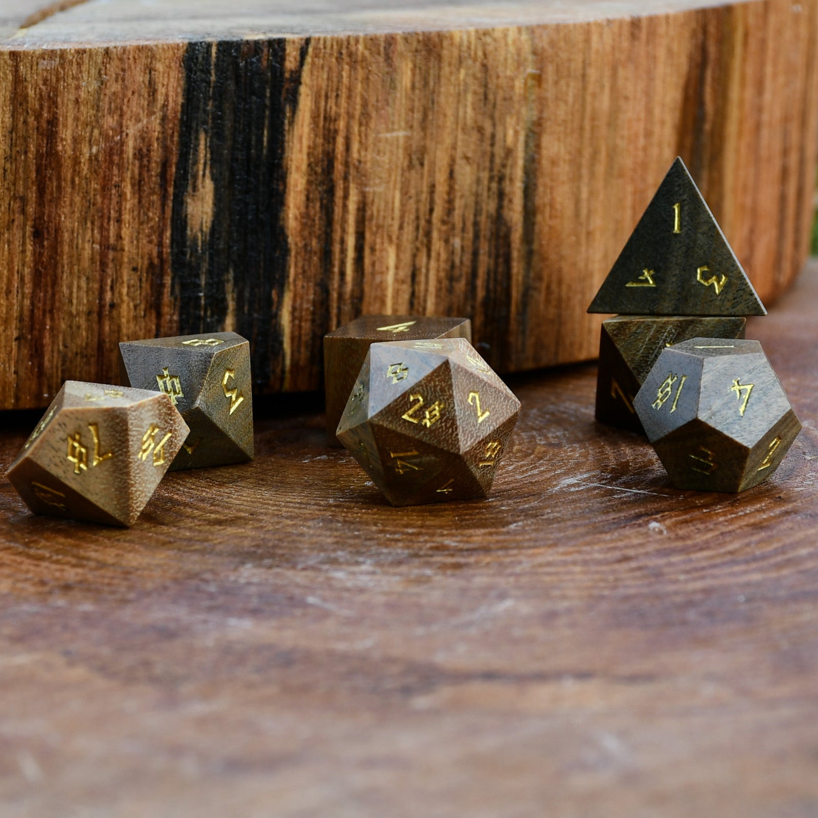Set of polyhedral wood dice on a wooden surface
