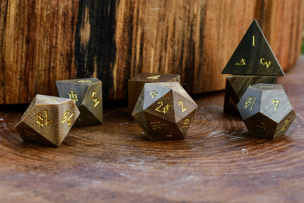 Set of polyhedral wood dice on a wooden surface