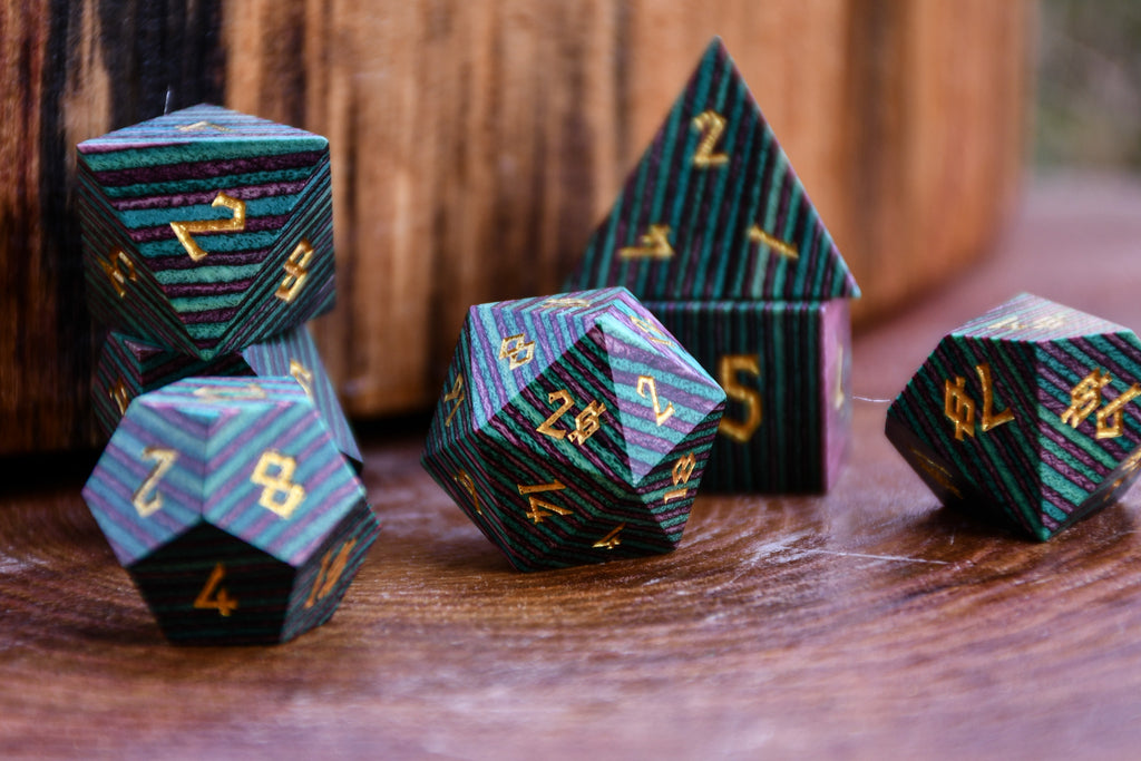 purple and green wooden dice for tabletop gaming 