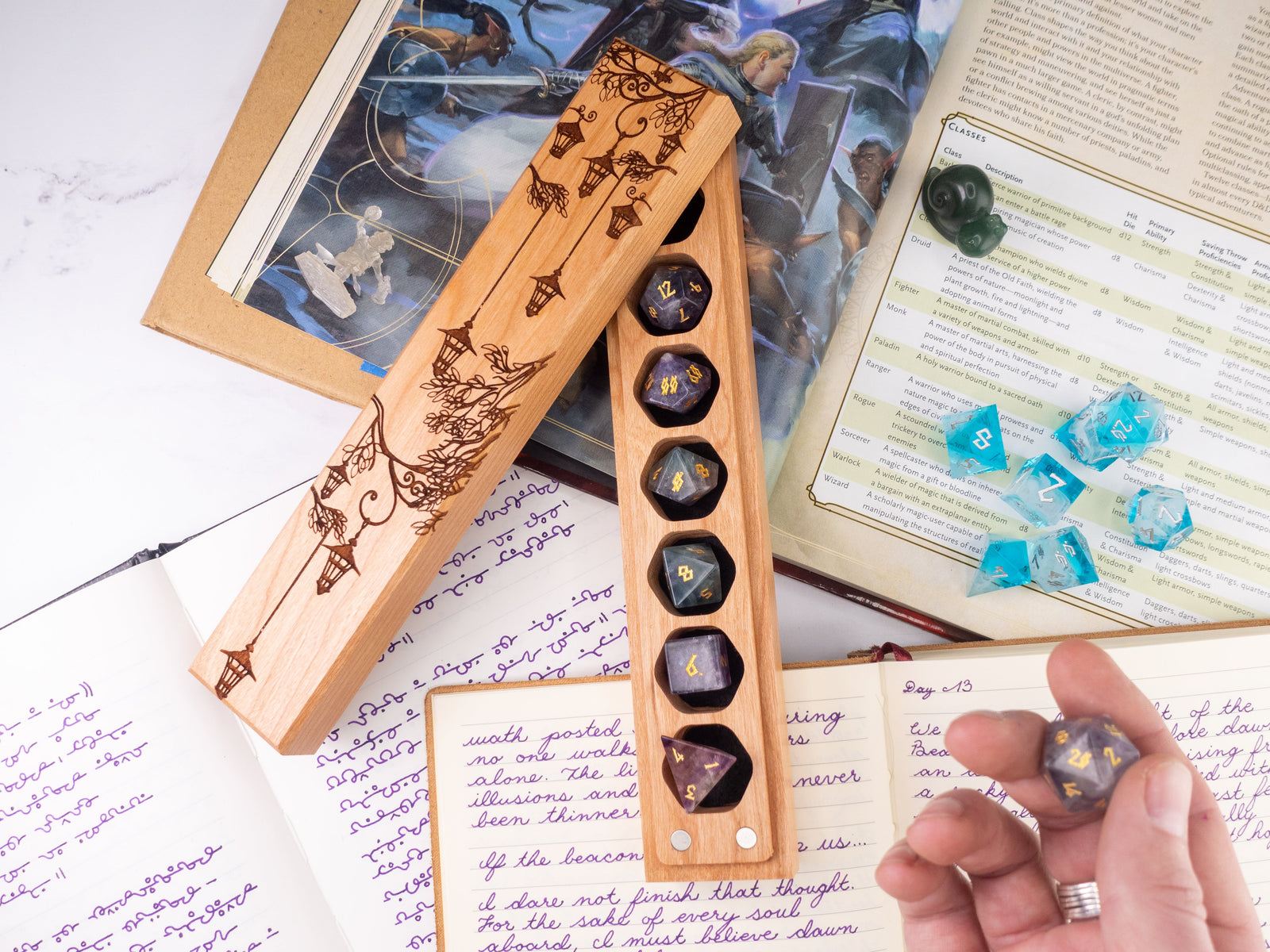 Wooden dice holder with engraved design on a table with gaming materials