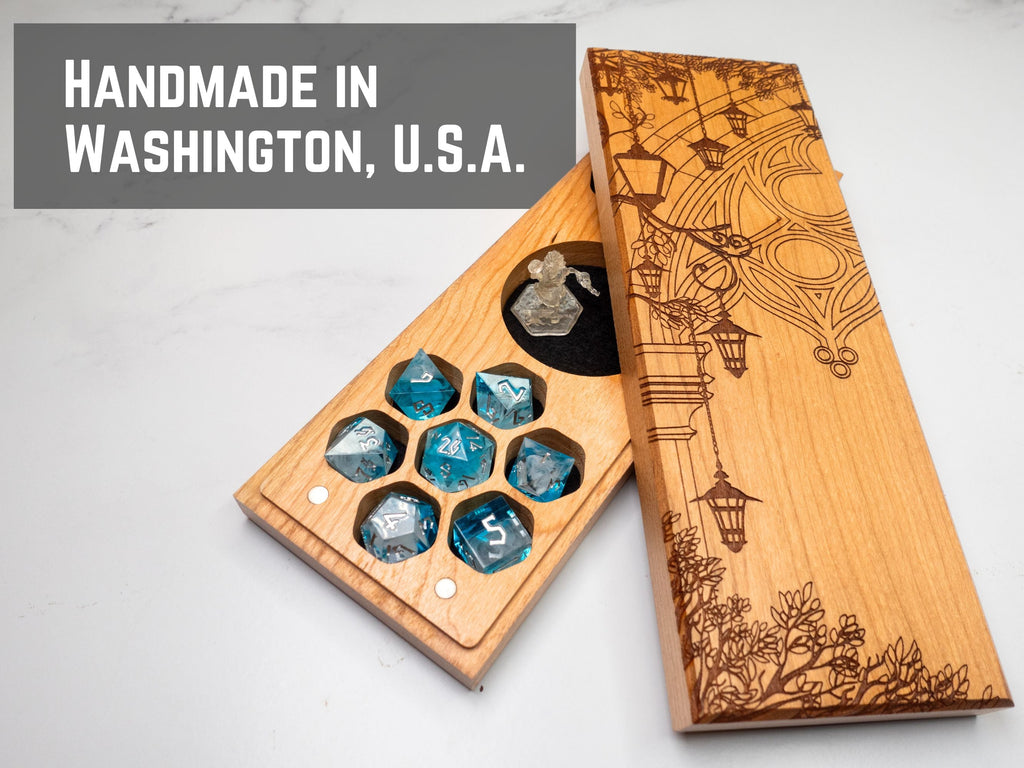Wooden dice set with engraved design on a white background, featuring 'Handmade in Washington, U.S.A.' text.
