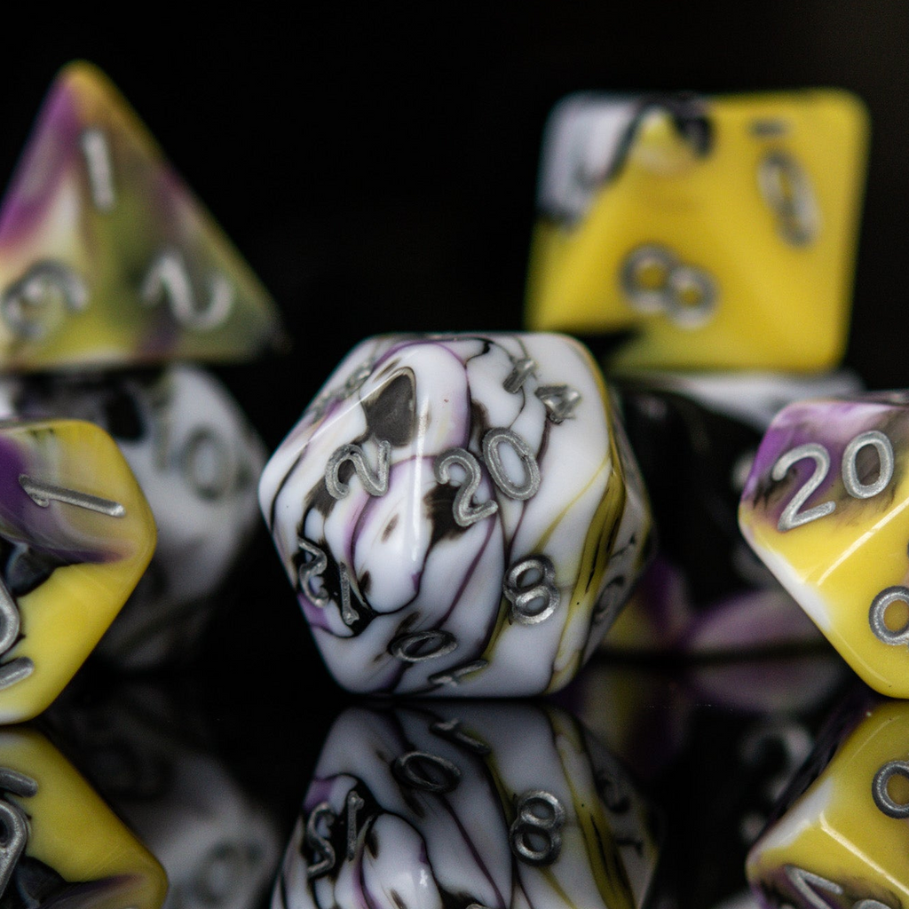 Marbled dice with numbers on a reflective surface