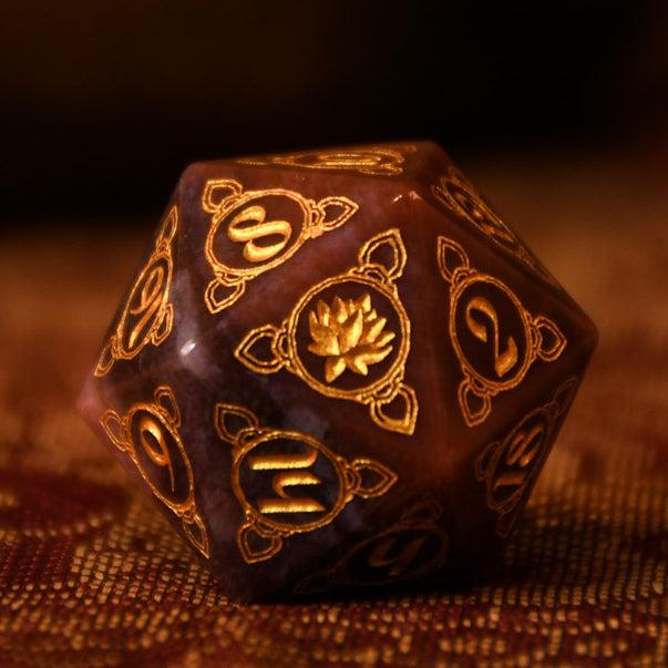 A set of hand-carved Indian Agate stone dnd dice with engraved patterns, displayed on a wooden surface.