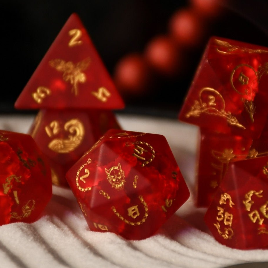 A set of hand-carved polyhedral Japanese Frosted Red Glass dnd dice with golden numbering and patterns. 