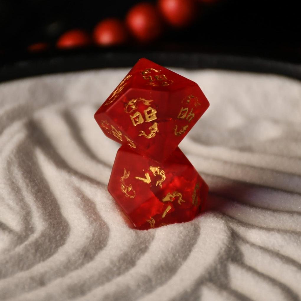 A set of hand-carved polyhedral Japanese Frosted Red Glass dnd dice with golden numbering and patterns. 