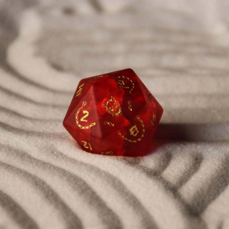 A set of hand-carved polyhedral Japanese Frosted Red Glass dnd dice with golden numbering and patterns. 