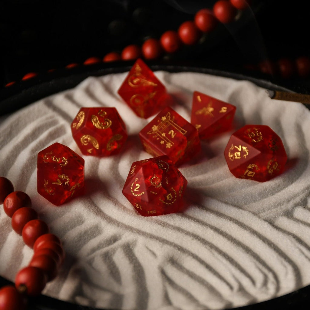 A set of hand-carved polyhedral Japanese Frosted Red Glass dnd dice with golden numbering and patterns. 