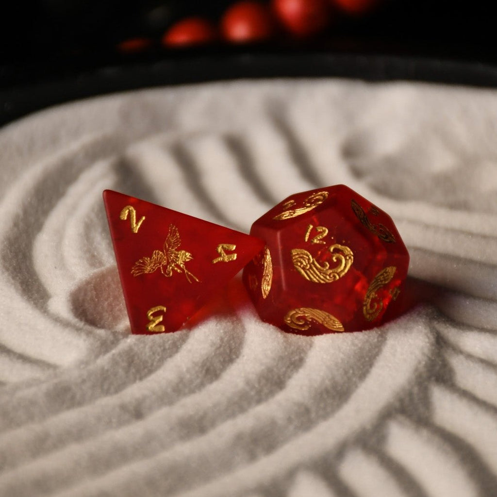 A set of hand-carved polyhedral Japanese Frosted Red Glass dnd dice with golden numbering and patterns. 