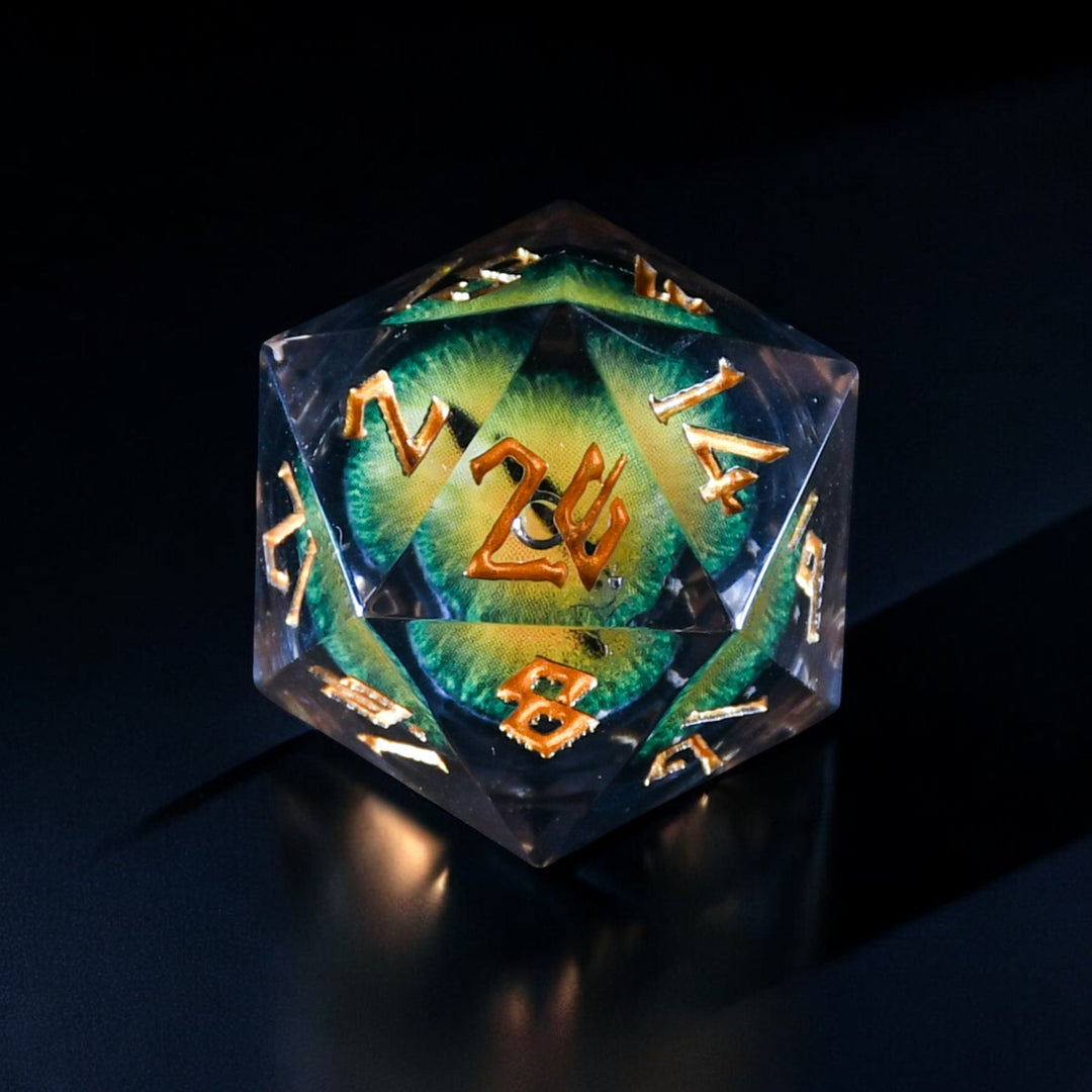 A set of yellow resin liquid core dice with green dragon eyes for tabletop gaming