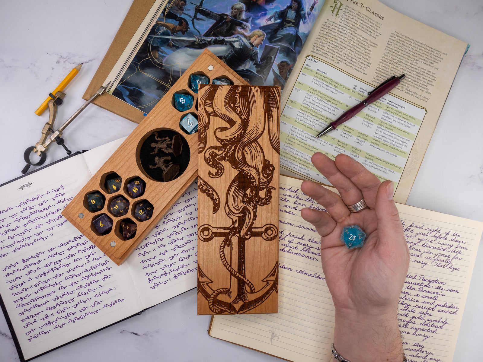Wooden dice tray with engraved design on a table with gaming materials