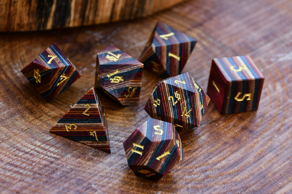 Wooden dice set with striped patterns on a wooden surface