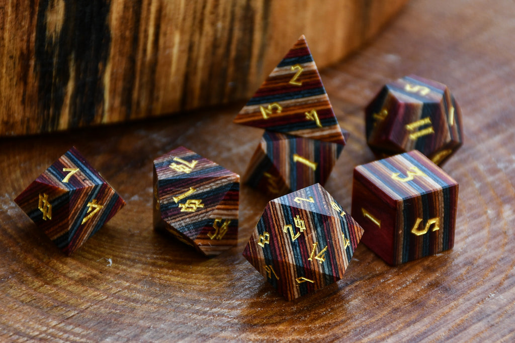 Wooden dice set with striped pattern on a wooden surface