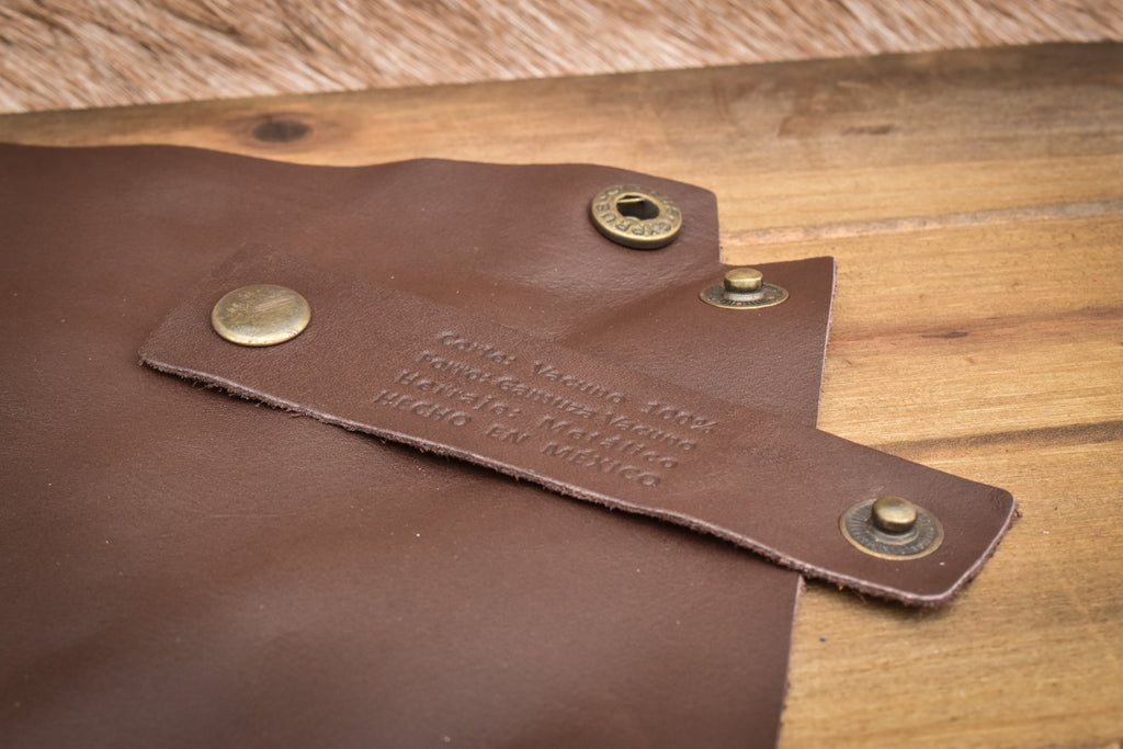 A semi-gloss brown leather collapsible dice tray displayed on a wooden surface.