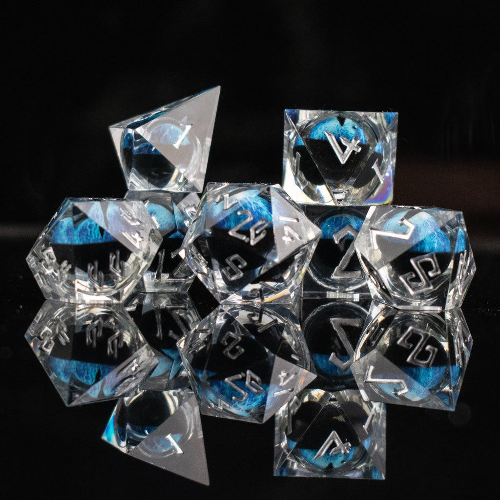 Clear polyhedral dice with blue and black numbers on a black background