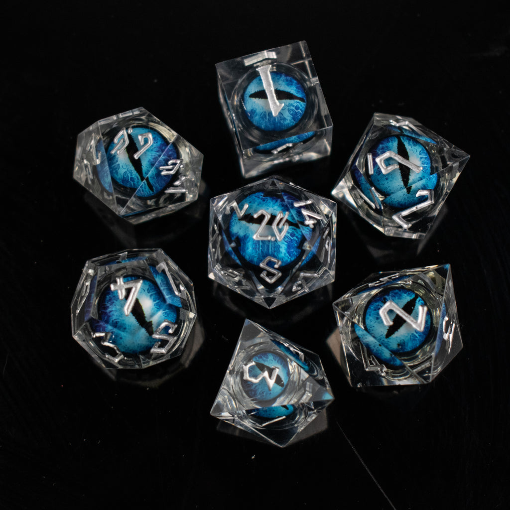 Clear polyhedral dice with blue and black numbers on a black background