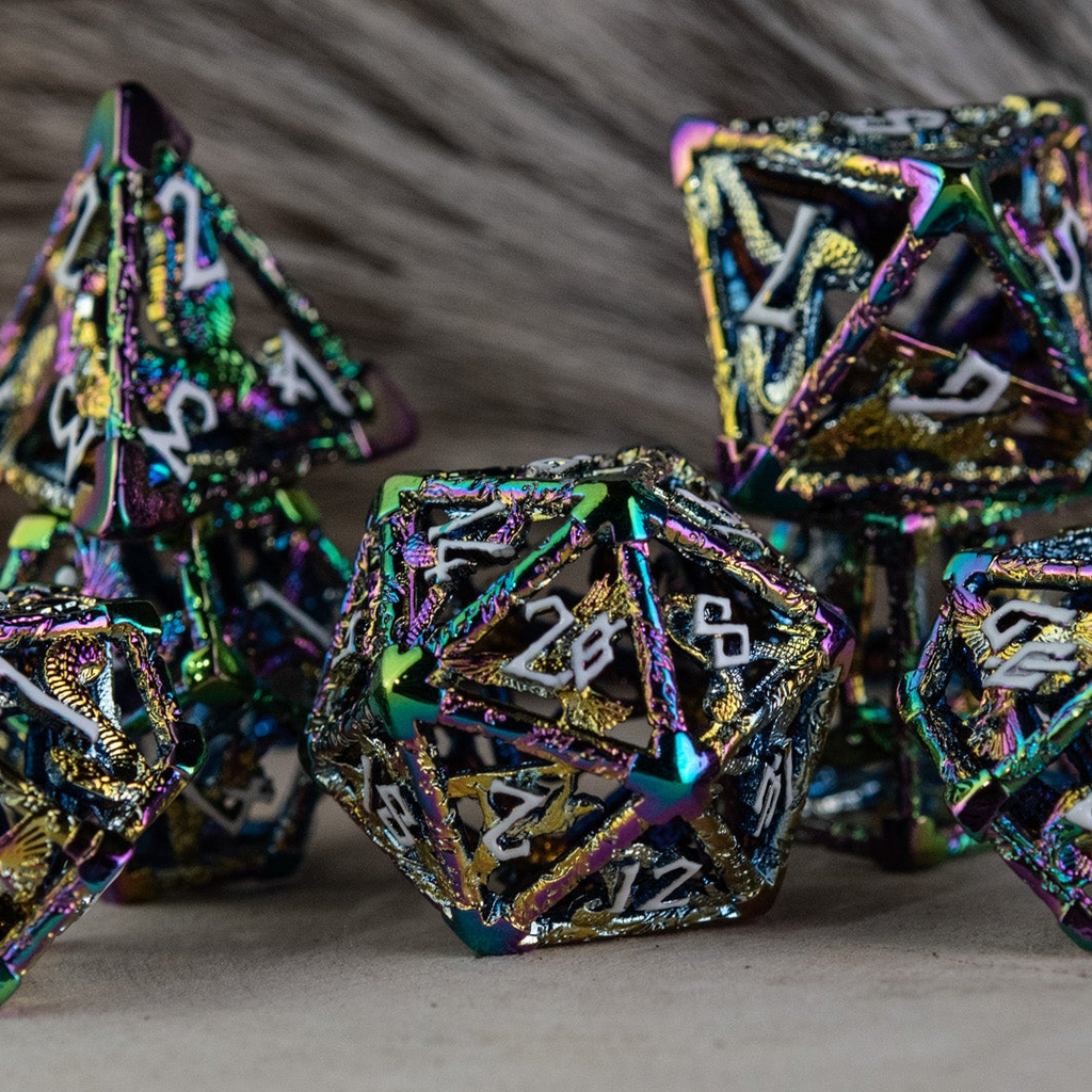A set of iridescent hollow metal dice inincluding various shapes such as a d4, d6, d8, d10, d12, and d20, displayed on a reflective surface.