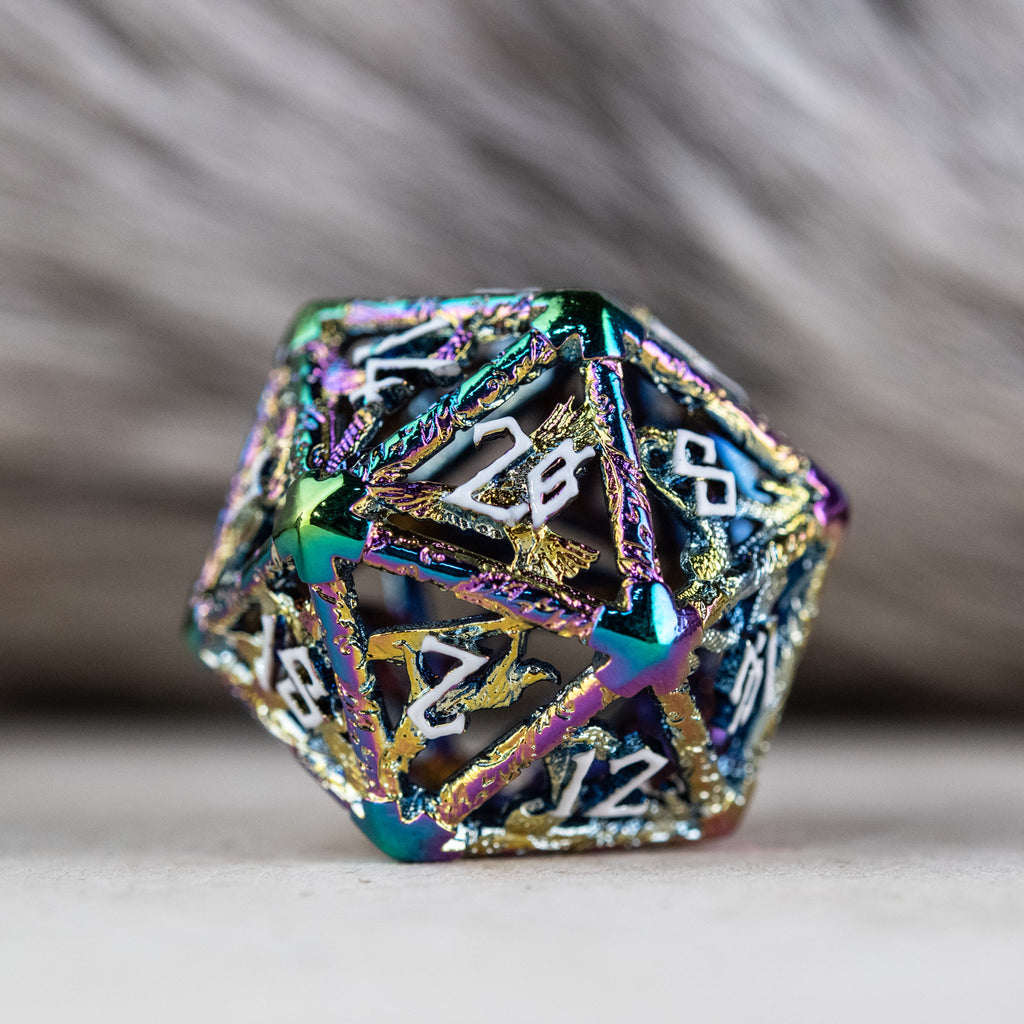 A set of iridescent hollow metal dice inincluding various shapes such as a d4, d6, d8, d10, d12, and d20, displayed on a reflective surface.