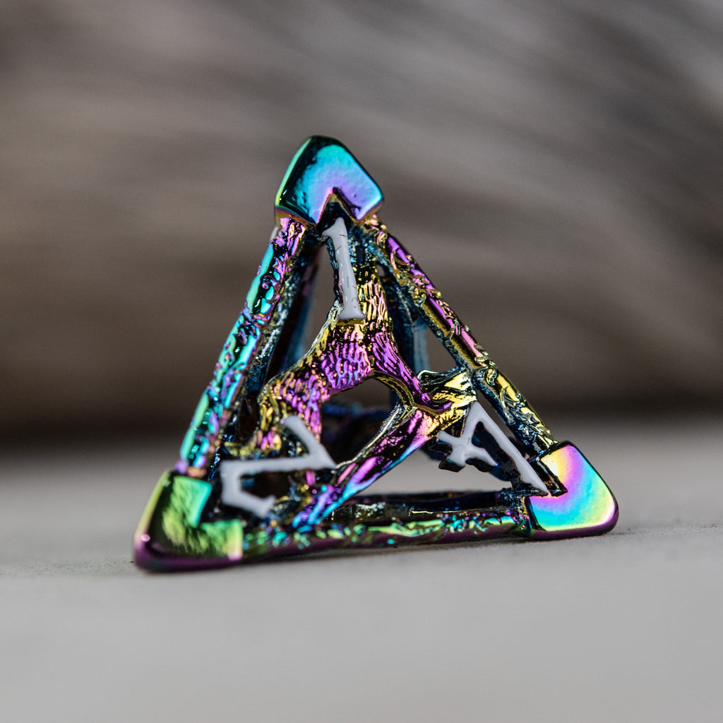 A set of iridescent hollow metal dice inincluding various shapes such as a d4, d6, d8, d10, d12, and d20, displayed on a reflective surface.