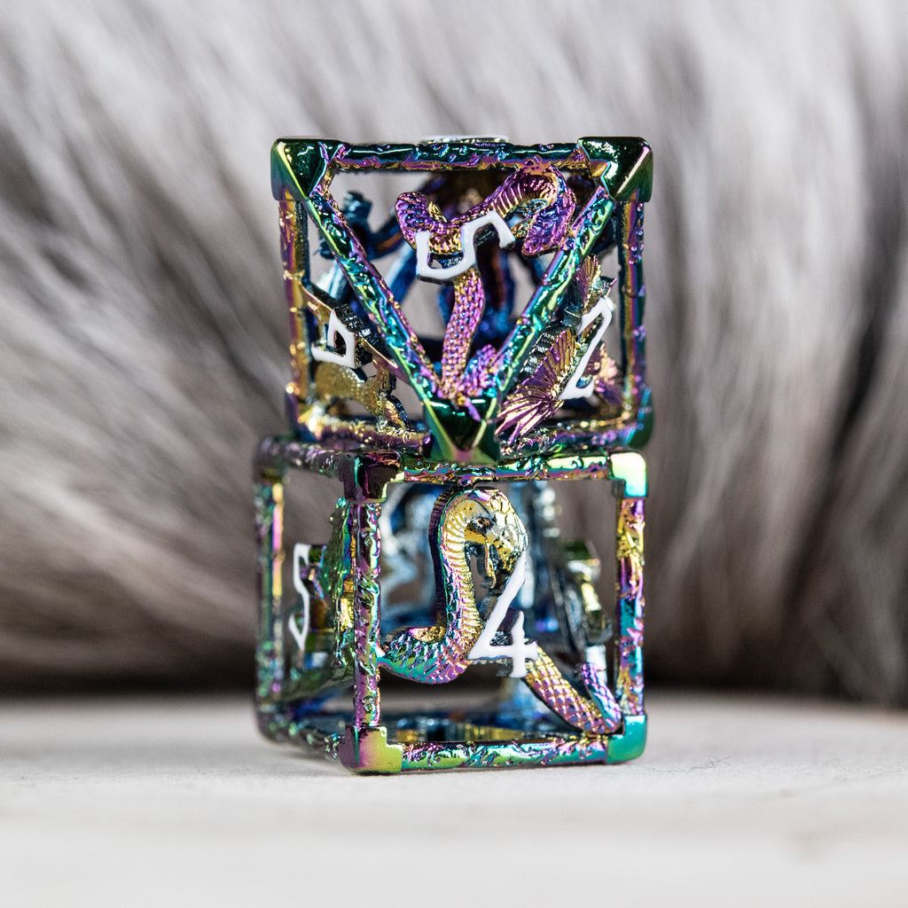 A set of iridescent hollow metal dice inincluding various shapes such as a d4, d6, d8, d10, d12, and d20, displayed on a reflective surface.