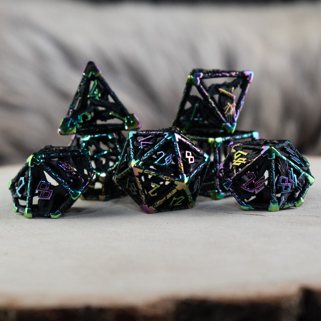 A set of black and iridescent hollow metal dice with embossed numbers, including various shapes commonly used in RPGs.