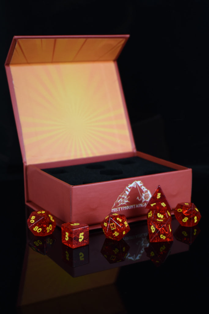A set of red glass dice with engraved numbers, displayed in front of a Megacon Orlando backdrop.