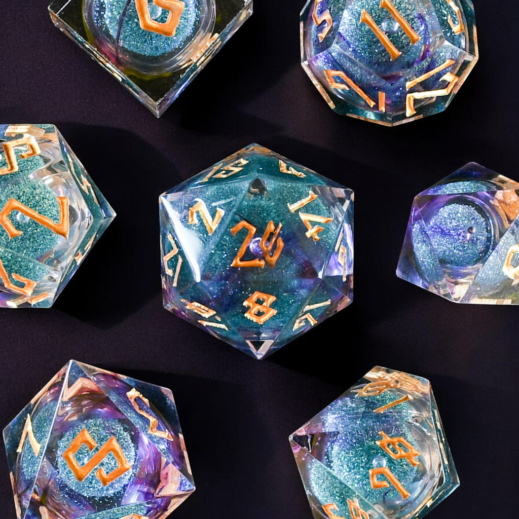 A set of resin liquid core dice with purple and blue glitter, hand-crafted and painted with engraved numbers for tabletop RPG games.
