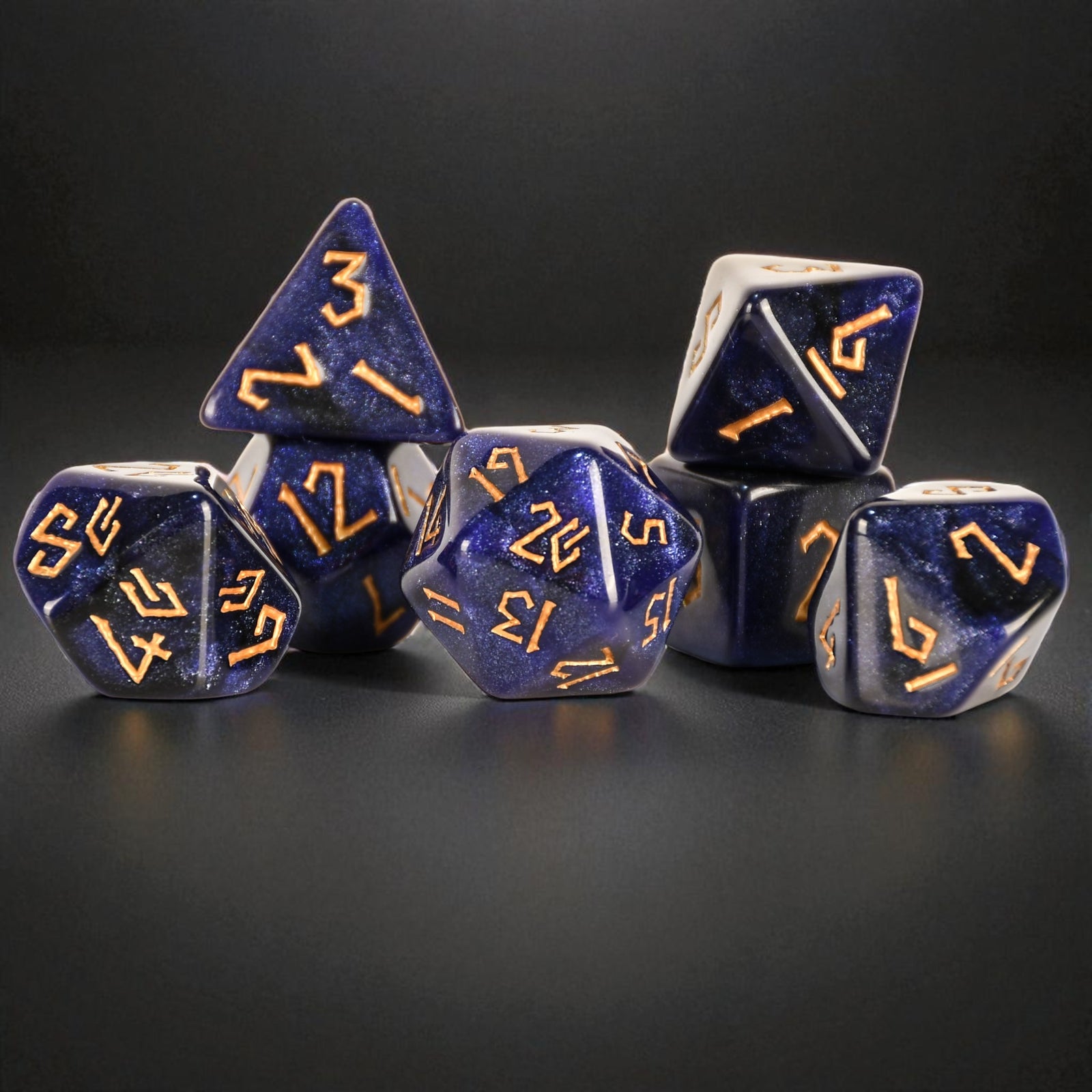 Blue polyhedral dice with gold numbers on a black background