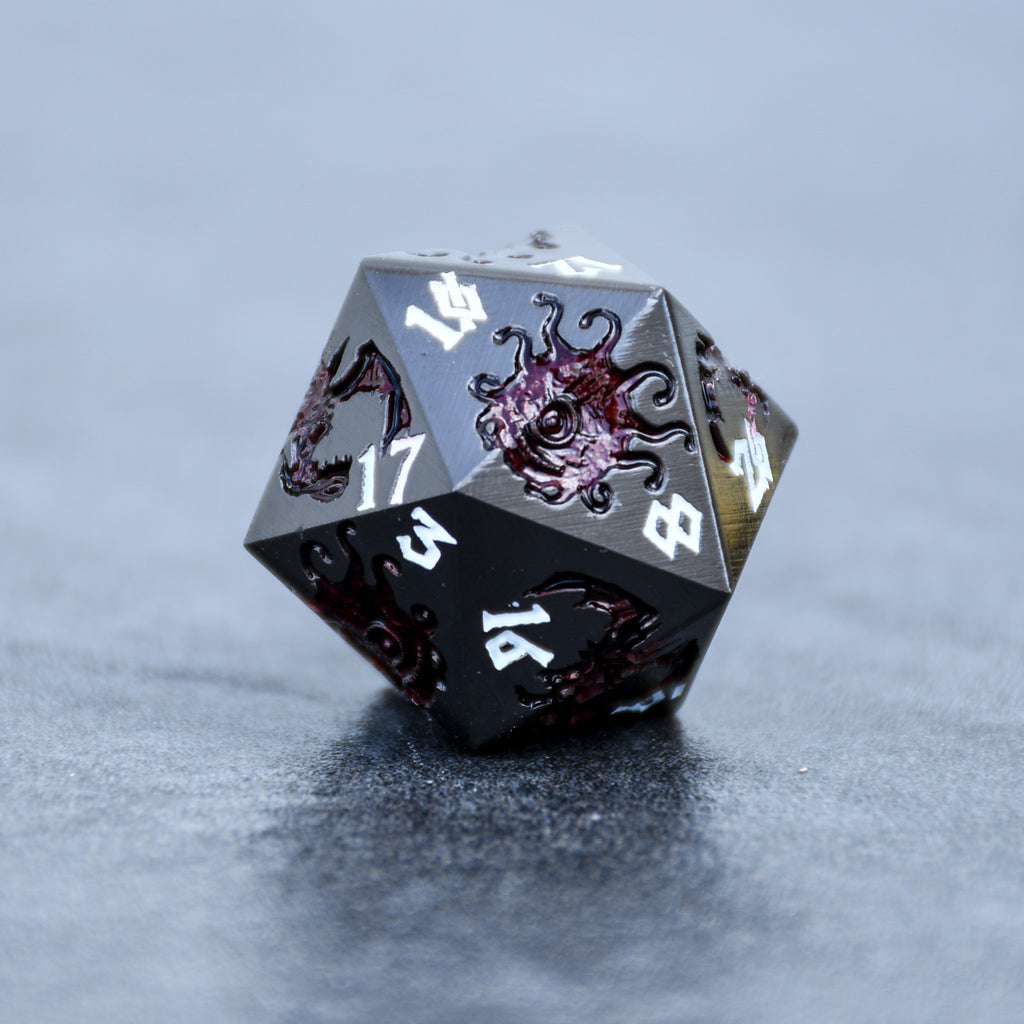 A set of metal dice in gunmetal and crimson color with engraved dragons and beholders in crimson read and white numbers 