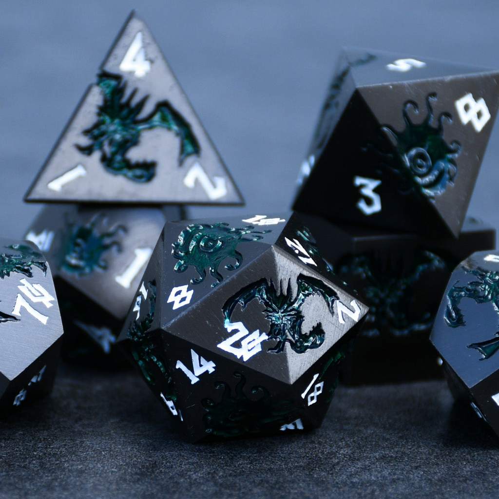 A set of metal dice in gunmetal and green color with engraved numbers, including various shapes such as a d4, d6, d8, d10, d12, and d20, displayed on a dark surface.